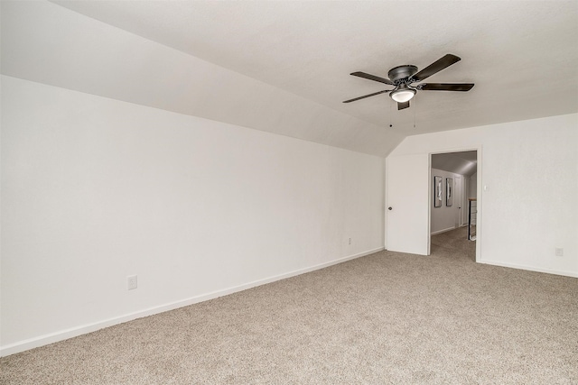 interior space featuring carpet, vaulted ceiling, and ceiling fan