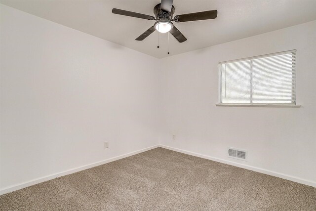 spare room featuring carpet and ceiling fan