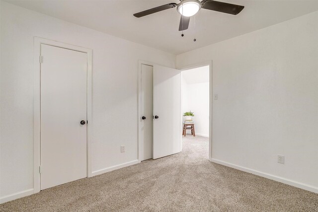 unfurnished bedroom with ceiling fan and light carpet