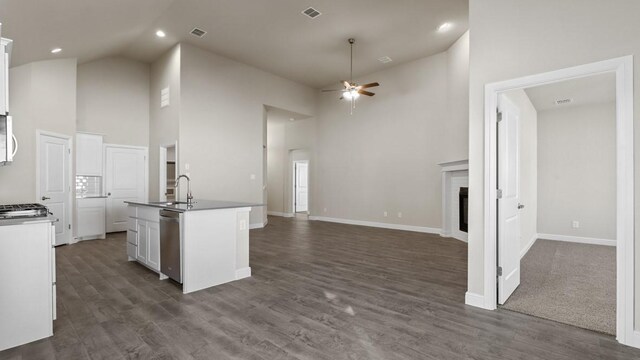 spare room featuring ceiling fan, plenty of natural light, a raised ceiling, and light wood-type flooring