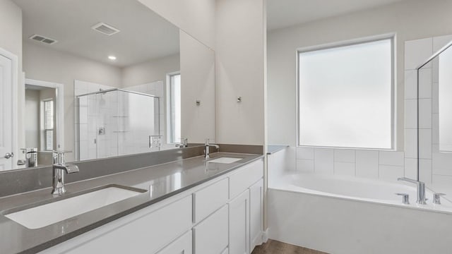 bathroom featuring independent shower and bath and wood-type flooring