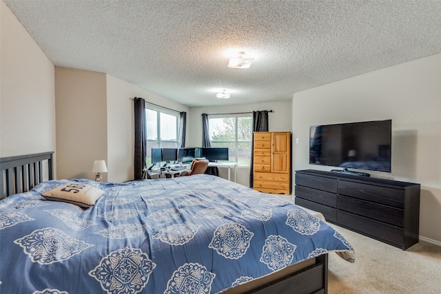 bedroom featuring a textured ceiling and light colored carpet