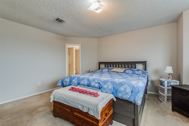 bedroom featuring a textured ceiling and light carpet