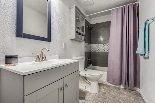 full bathroom featuring shower / tub combo with curtain, vanity, a textured ceiling, and toilet