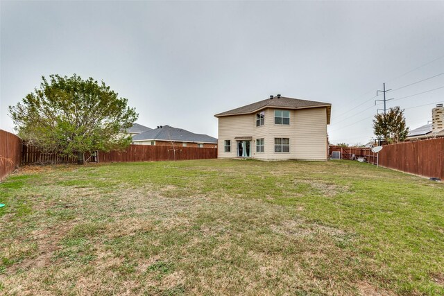 rear view of property featuring a yard