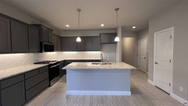 kitchen with white cabinets, light stone countertops, sink, and stainless steel appliances