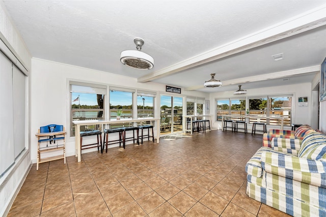 sunroom / solarium featuring beamed ceiling