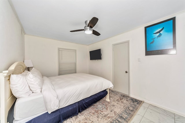 bedroom with ceiling fan and crown molding