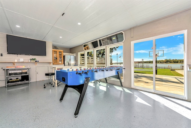 recreation room with a water view and plenty of natural light