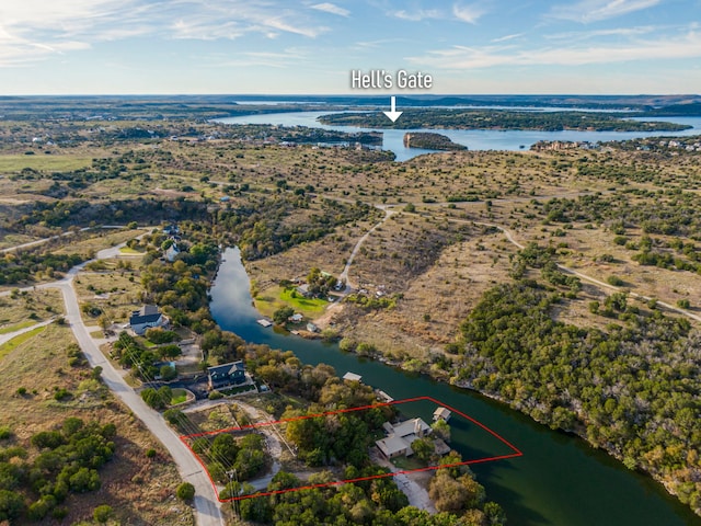 1133 Brackeen Dr, Graford, TX 76449 - aerial view of property and surrounding area featuring property parcel outlined and a nearby body of water