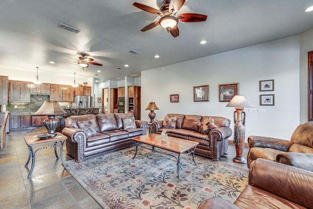 1133 Brackeen Dr, Graford, TX 76449 - living room featuring ceiling fan, recessed lighting, and stone finish flooring