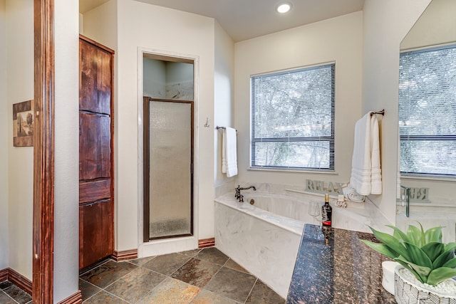 1133 Brackeen Dr, Graford, TX 76449 - bathroom with a shower stall, a garden tub, stone tile floors, baseboards, and recessed lighting