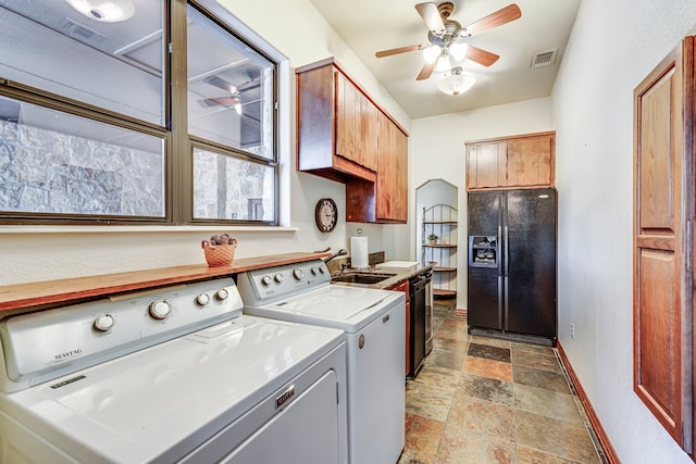 1133 Brackeen Dr, Graford, TX 76449 - laundry room featuring independent washer and dryer, a sink, stone finish flooring, ceiling fan, and baseboards