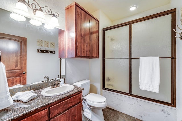 1133 Brackeen Dr, Graford, TX 76449 - bathroom with vanity, shower / bath combination with glass door, and toilet
