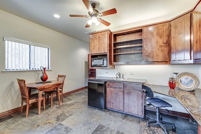 1133 Brackeen Dr, Graford, TX 76449 - kitchen featuring built in microwave, baseboards, black dishwasher, a sink, and open shelves