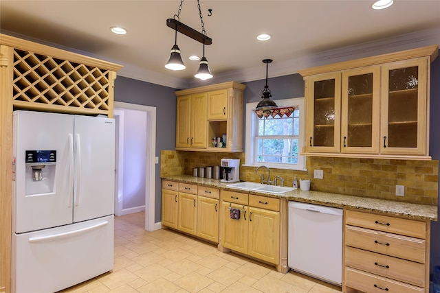 kitchen featuring sink, light stone counters, hanging light fixtures, white appliances, and decorative backsplash