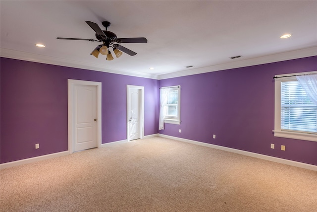 carpeted spare room featuring ceiling fan and crown molding