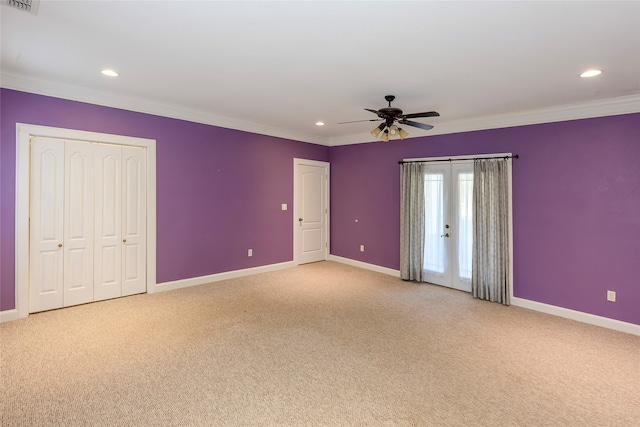 unfurnished bedroom with ornamental molding, light colored carpet, and ceiling fan