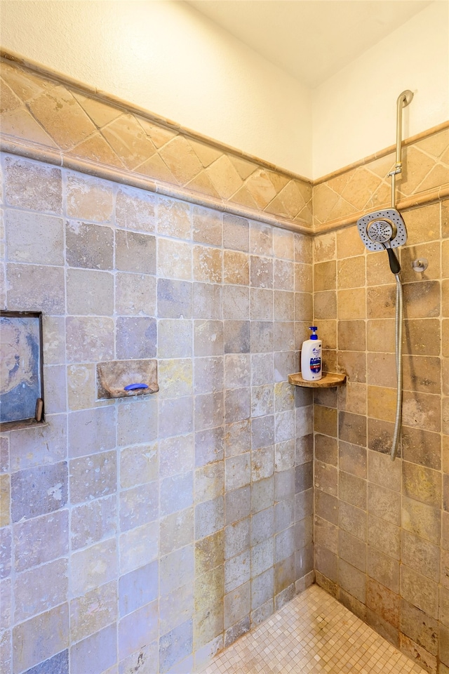 bathroom with a tile shower