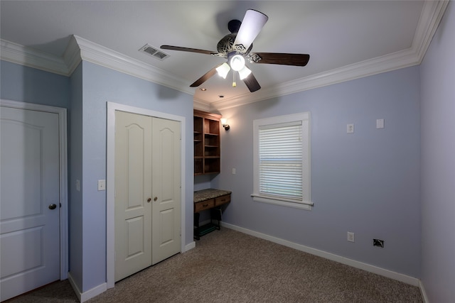 unfurnished bedroom featuring ceiling fan, carpet flooring, and crown molding