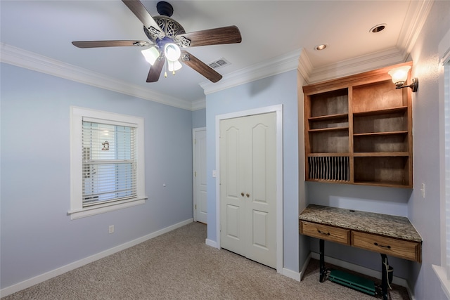 unfurnished office with light colored carpet, ceiling fan, and crown molding