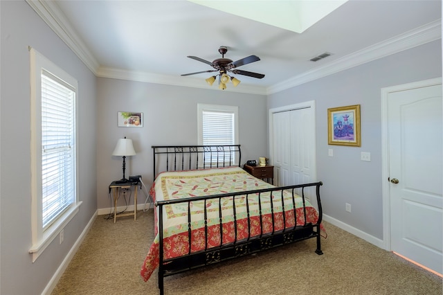 bedroom with ornamental molding, carpet, multiple windows, and ceiling fan