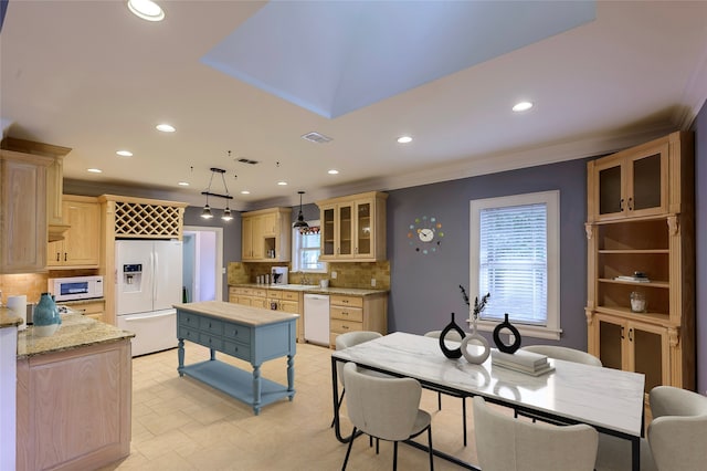 tiled dining area featuring crown molding