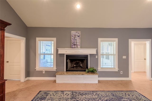 unfurnished living room with vaulted ceiling and a healthy amount of sunlight