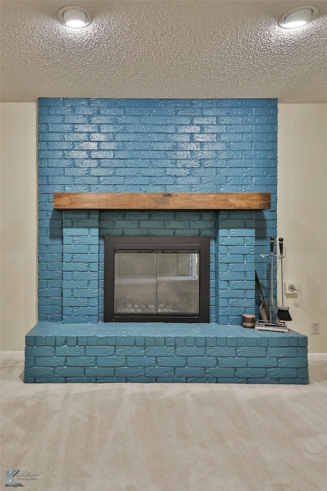 room details with carpet flooring, a textured ceiling, and a brick fireplace