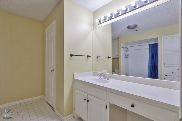 bathroom with vanity, a textured ceiling, a shower with shower curtain, and tile patterned flooring