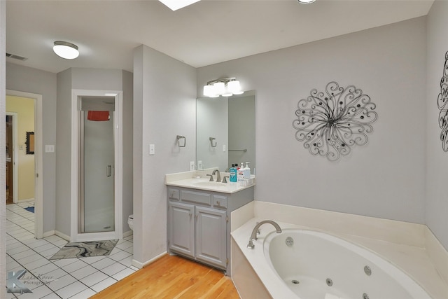 full bathroom featuring hardwood / wood-style floors, vanity, toilet, and independent shower and bath