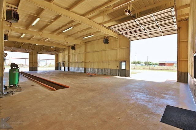 garage with a garage door opener and a carport