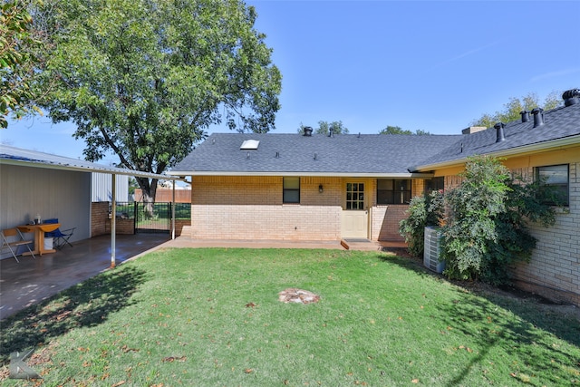 back of house with a lawn, central AC unit, and a patio