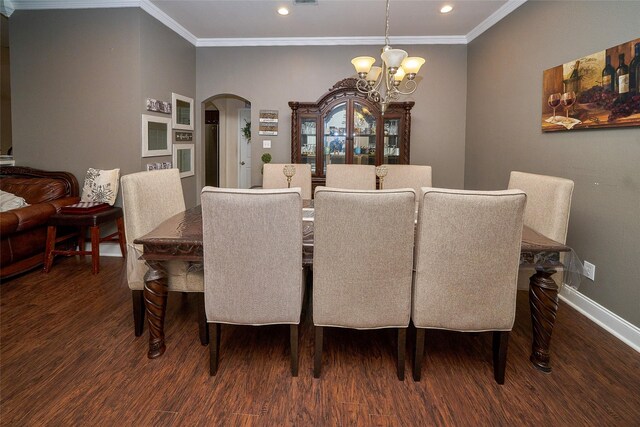 dining area featuring ornamental molding, dark wood-type flooring, and a notable chandelier