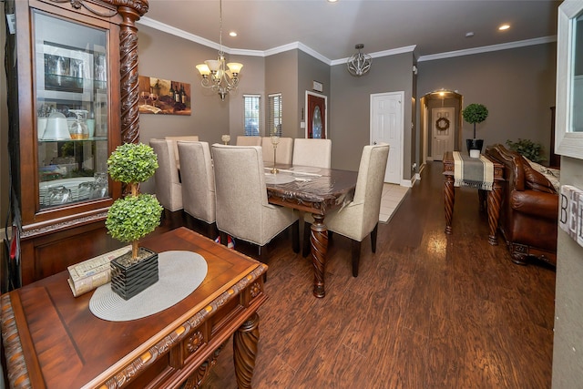 dining room with a chandelier, dark wood-type flooring, and ornamental molding