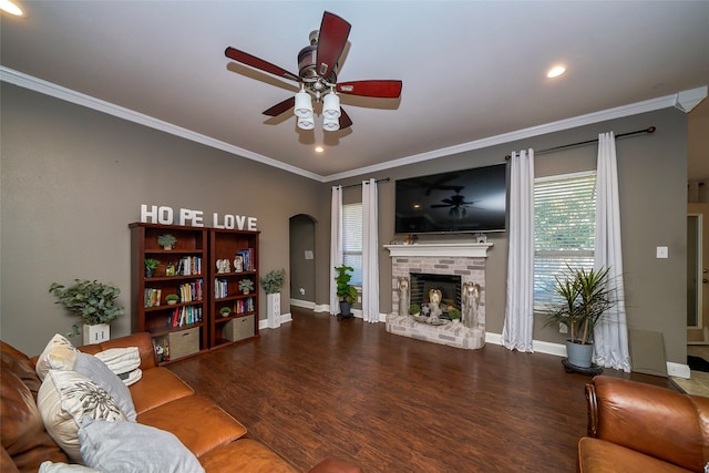 living room with a fireplace, hardwood / wood-style flooring, ceiling fan, and crown molding