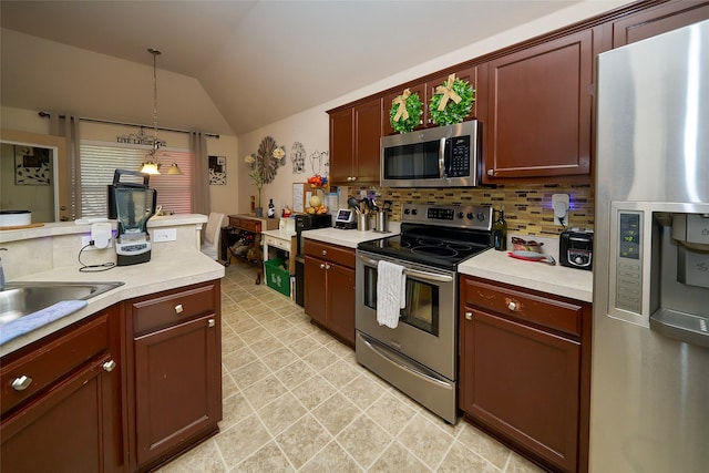 kitchen with sink, pendant lighting, vaulted ceiling, decorative backsplash, and appliances with stainless steel finishes