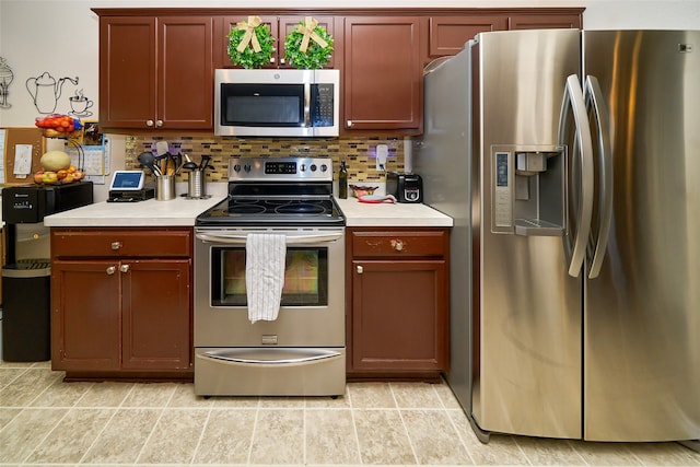 kitchen featuring decorative backsplash, light tile patterned floors, and appliances with stainless steel finishes