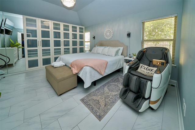 bedroom featuring lofted ceiling