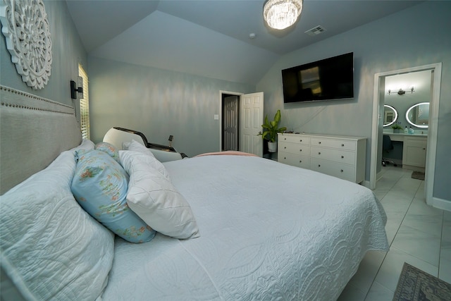 tiled bedroom featuring connected bathroom and lofted ceiling