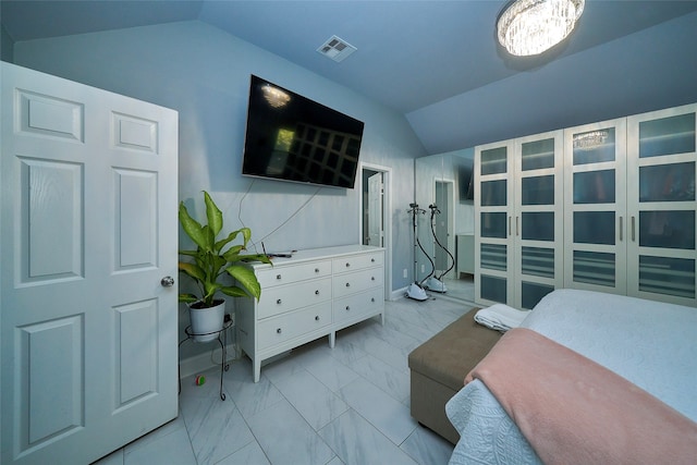 bedroom with a notable chandelier and lofted ceiling