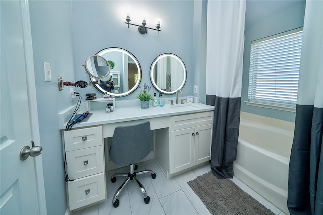 bathroom featuring vanity and a tub