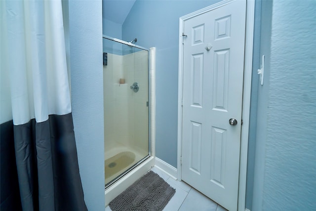 bathroom with tile patterned floors and a shower with shower door