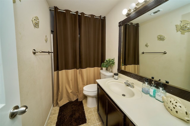 bathroom with tile patterned floors, vanity, and toilet