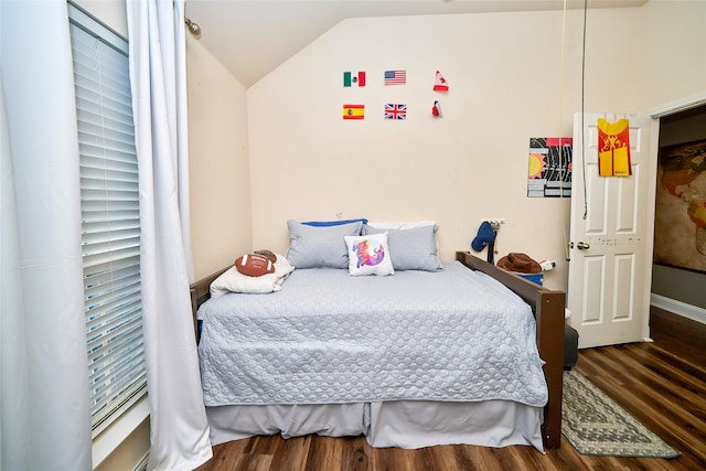 bedroom featuring dark hardwood / wood-style flooring and lofted ceiling