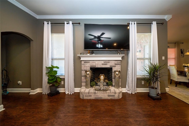 unfurnished living room featuring ceiling fan, dark hardwood / wood-style floors, ornamental molding, and a wealth of natural light