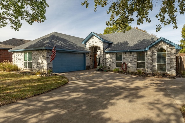 view of front of property with a garage and a front lawn