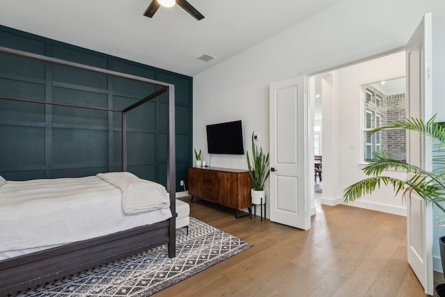 bedroom with hardwood / wood-style floors and ceiling fan