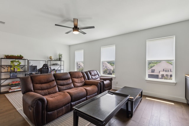 living room with ceiling fan and dark wood-type flooring