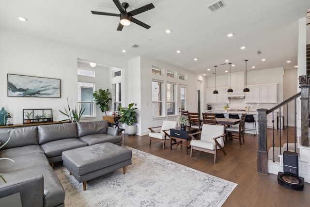 living room with dark hardwood / wood-style floors and ceiling fan